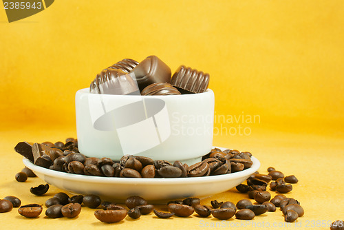 Image of Cup full with coffee beans and chocolate candies