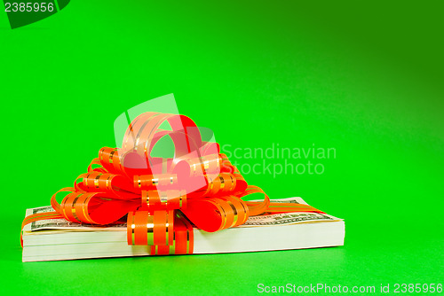 Image of Stack of US 100 dollar bills tied up with a ribbon