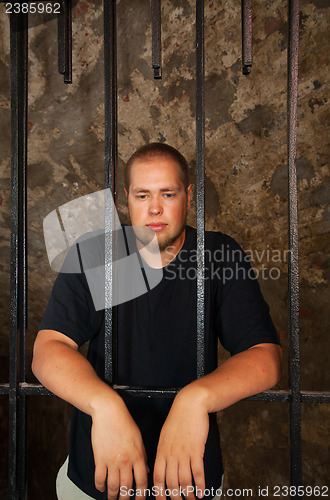 Image of Young man behind the bars