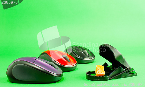 Image of Three computer mouses with a mousetrap