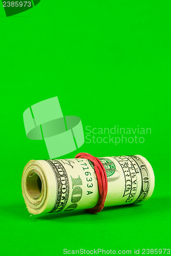 Image of Roll of US dollars tied up with rubber