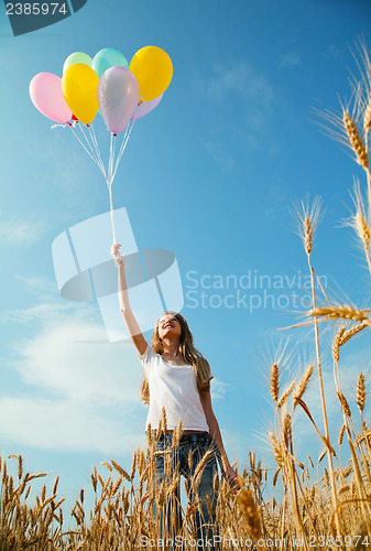 Image of Teen girl at a wheat field with balloons