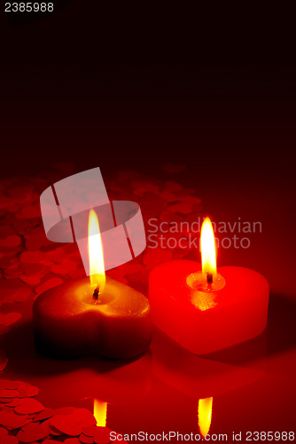 Image of Two burning heart shaped candles