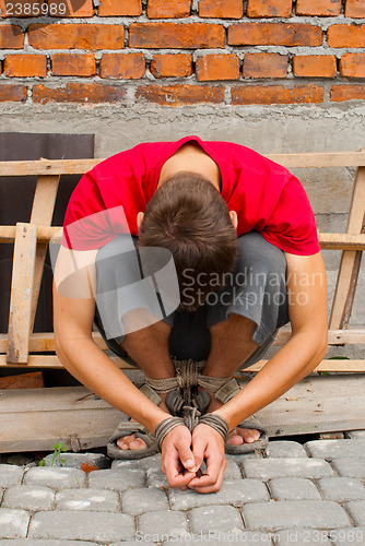 Image of Man tied up with rope