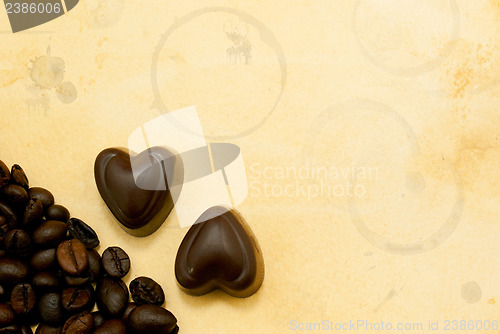Image of Two heart shaped chocolate candies and coffee beans