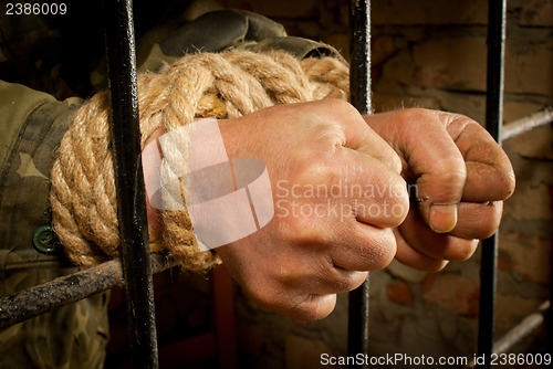 Image of Man with hands tied with rope