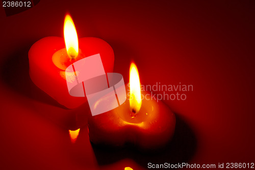 Image of Two burning heart shaped candles