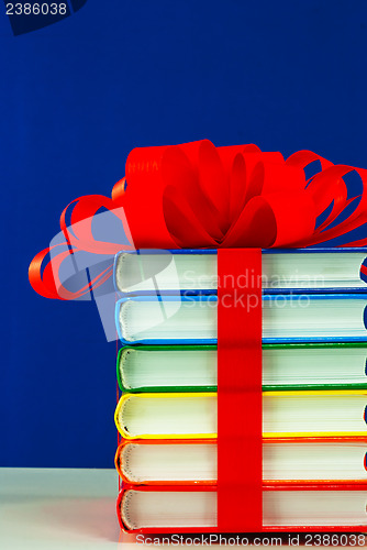 Image of Stack of colorful books tied up with ribbon