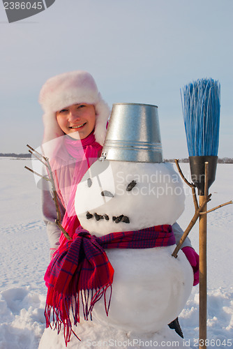 Image of Teenage girl with snowman