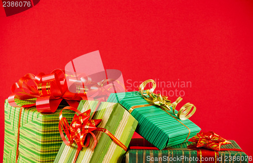 Image of Wrapped boxes with presents against red background