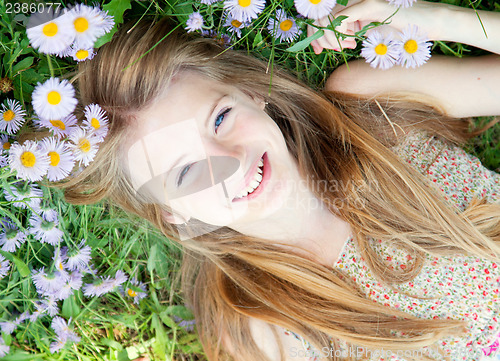 Image of Teen girl laying in grass