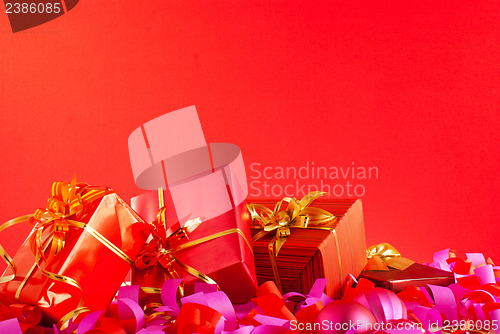 Image of Christmas gifts over red background