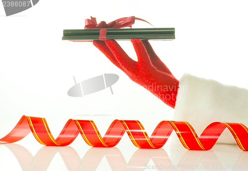 Image of Hand in red glove holds electronic book reader against white background