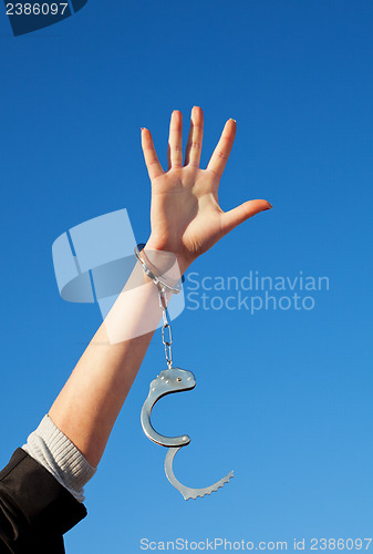 Image of Handcuffed woman's hand