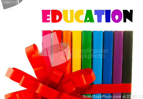 Image of Row of colorful books tied up with ribbon