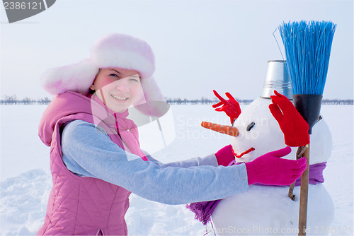Image of Teenage girl with snowman