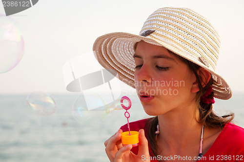 Image of Teen girl blowing bubbles