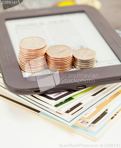 Image of Electronic book reader with bars of coins