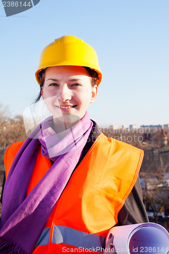 Image of Young lady architect staying outdoors