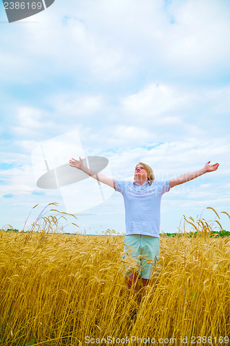 Image of Young man staying with raised hands