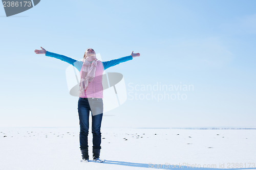 Image of Teen girl staying with raised hands