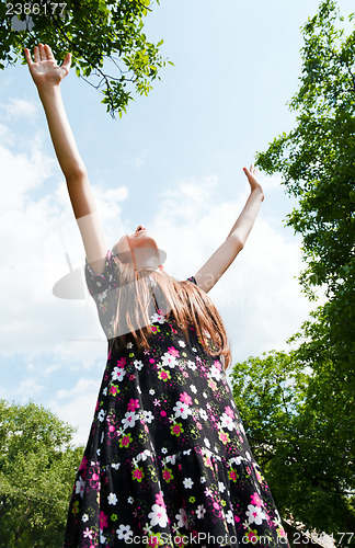 Image of Teen girl with raised hands