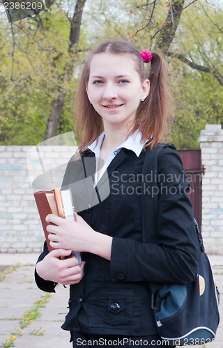 Image of Teen girl staying outdoors at summer time