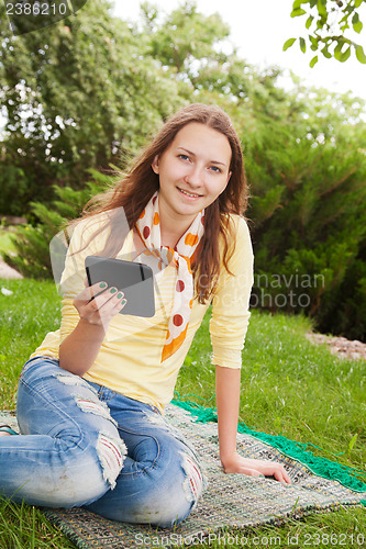 Image of Teen girl reading electronic book