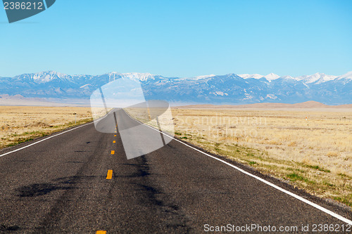 Image of Empty freeway approaching mountains range