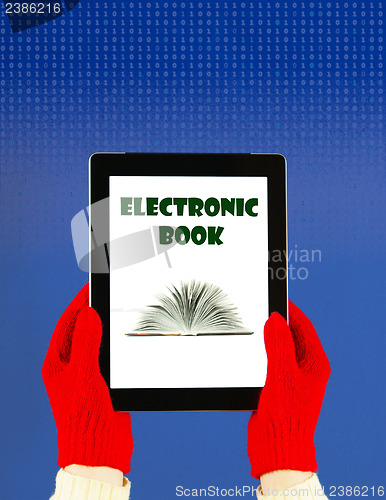 Image of Hands wearing red gloves holding a tablet PC