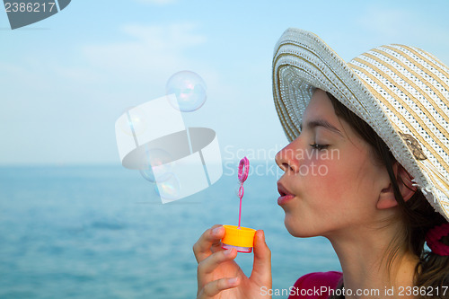Image of Teen girl blowing bubbles