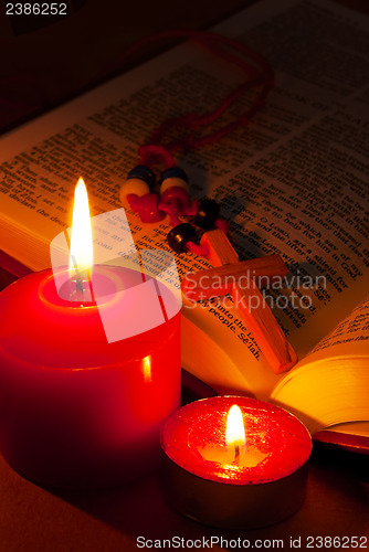 Image of Open Bible with cross and burning candles