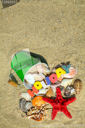 Image of Wooden colorful word 'Holiday' on the sand