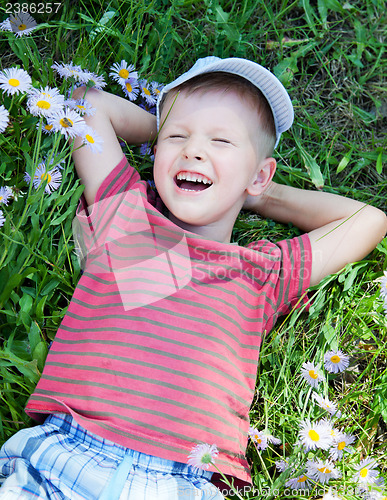Image of Small boy lying on the grass