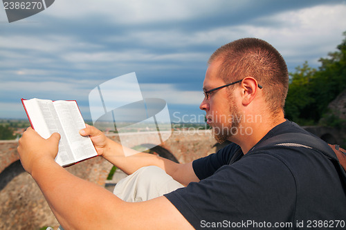 Image of Young man reading the Bible