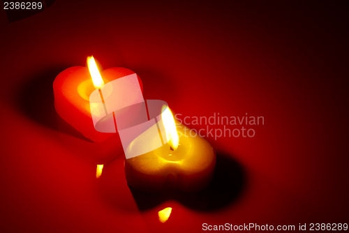 Image of Two burning heart shaped candle