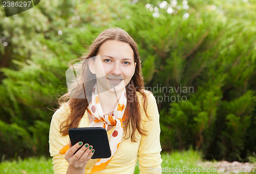 Image of Teen girl reading electronic book