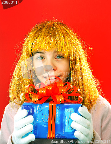 Image of Teen girl with a present against red background