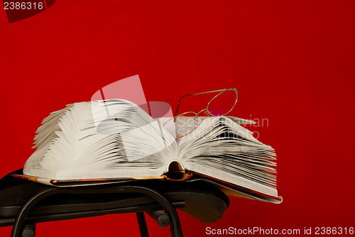 Image of Open book laying on the chair 