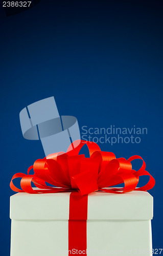 Image of White box with present against blue background