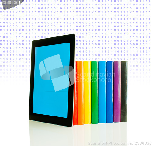 Image of Row of colorful books and tablet PC over white background