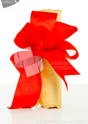 Image of Ancient scroll tied up by red ribbon 