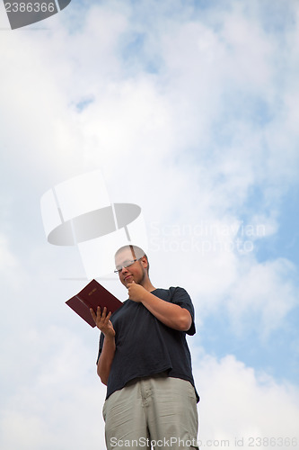Image of Young man staying with the Bible