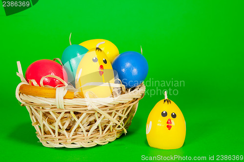 Image of Basket with the Easter eggs and yellow chicken candle