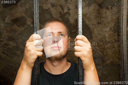 Image of Young man behind the bars