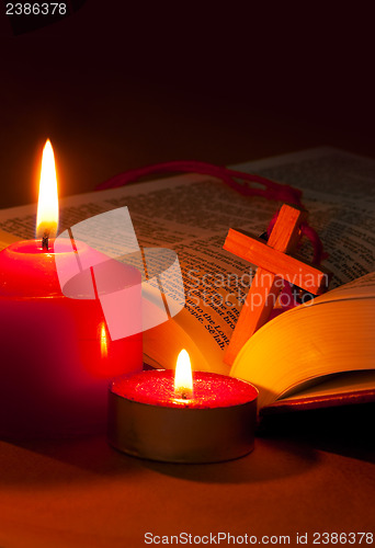 Image of Open Bible with cross and burning candles