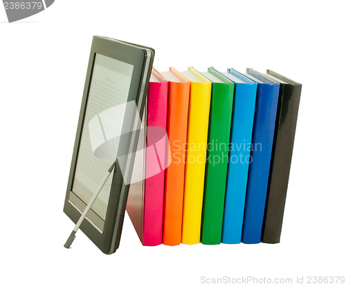 Image of Stack of colorful books and electronic book reader