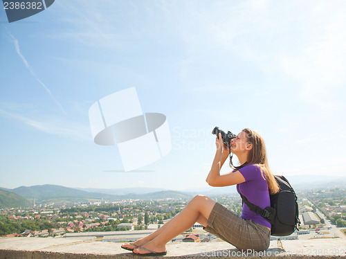 Image of Young lady photographer outdoors