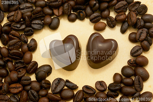 Image of Two heart shaped chocolate candies and coffee beans