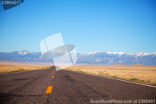 Image of Empty freeway approaching mountains range